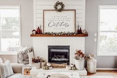 a living room filled with furniture and a fire place in front of a white brick fireplace