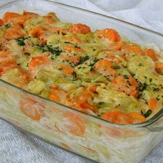 a casserole dish filled with carrots and other vegetables