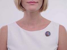 A stunning example of antique enamel work, this Victorian era diamond portrait brooch with a fold down pendant bail is a truly exquisite artifact. A young woman — luxuriously outfitted in the vestments of the early 16th century including slashed sleeves, an elaborate bejeweled headdress, collar necklace and emerald and pearl brooch — is set against a backdrop of diagonal stripes. The stripes consist of rose-cut diamonds and deep blue enamel adorned with white fleurs de lis. A border of rose-cut Victorian Brooches For Ceremonial Occasions, Victorian Enamel Brooches For Formal Occasions, Victorian Style Enamel Pin Gift, Wedding Enamel Pin Brooch, Victorian Oval Brooch Jewelry, Victorian Enamel Brooches As Gift, Antique Oval Gemstone Brooch, Victorian Silver Enamel Brooches, Jewellery Marketing