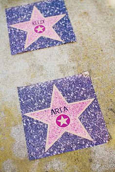 two pink and purple star stickers on the ground next to each other with name written on them