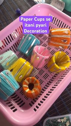 there are many different colored cups in the basket