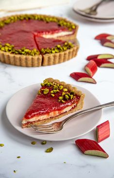 a piece of pie with pistachios on top is sitting on a plate