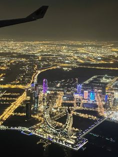 an airplane flying over a city at night