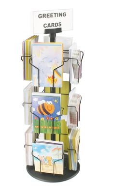 a bunch of greeting cards are stacked on top of each other in a display case