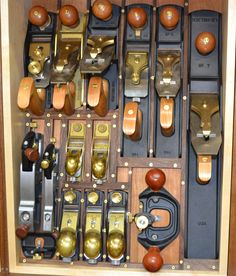 an assortment of wooden and metal objects in a box with handles, knobs, and locks