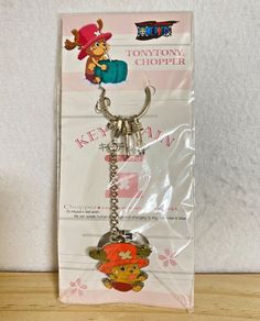 the key chain is shaped like winnie the pooh with a pirate hat on it