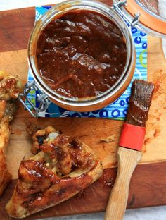 a wooden cutting board topped with meat and sauce