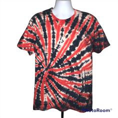 a red and black tie dye shirt on a mannequin head