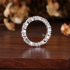 a diamond ring sitting on top of a wooden table