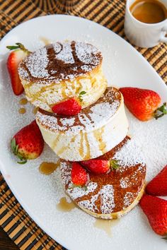 some powdered sugar and strawberries on a white plate