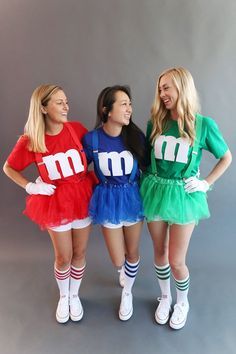 three women dressed in costumes standing next to each other