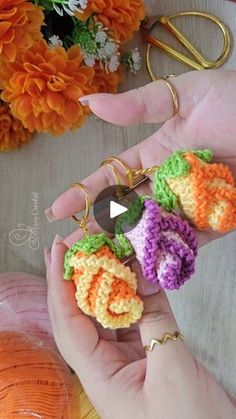 someone is holding some crocheted items in their hands and they are showing them off