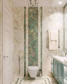 a bathroom with marble floors and walls