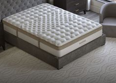 an image of a mattress in the middle of a room with a chair next to it