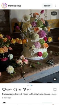 an image of a wedding cake with flowers on it