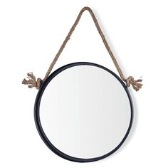 a round mirror hanging on a rope