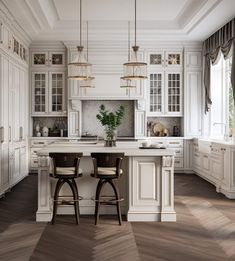 two stools sit at the center of a kitchen island