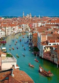 the boats are traveling down the canal in venice, italy as seen from above on a sunny day