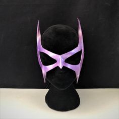 DESCRIPTIONGo retro! A lightweight purple leather mask for your '90s Catwoman Cosplay costume. Great Halloween Mask. Waterproofed leather, glossy or matte finish, & several choices to affix the mask (cord, elastic, ribbon, waterproof cord, stick, or no holes for adhesive). Measurements: 13" high x 11" wide (tallest & widest points); 0.5" high between the eyes; 2.5" wide x 2" tall eye openings ---------------------------------------------------------------------------- ALL OF OUR MASKS AR Purple Masks And Prosthetics For Halloween Masquerade, Purple Halloween Masquerade Masks And Prosthetics, Purple Mask For Costume Party, Purple Halloween Mask And Prosthetics, Villian Cosplay, Catwoman Mask, Catwoman Cosplay, Superhero Masks, Elastic Ribbon