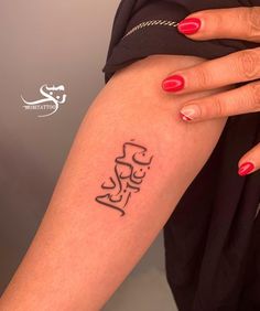 a woman's arm with a tattoo on it that has the word love written in cursive writing