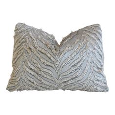 a silver and black pillow with zebra print on the front, sitting on a white background