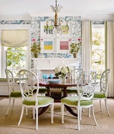 a dining room table with four chairs and a chandelier hanging from the ceiling