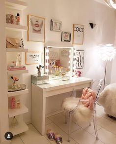 a white desk topped with a mirror next to a bed