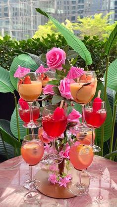 a table topped with lots of glasses filled with different types of drinks on top of it