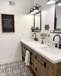 a bathroom with two sinks and mirrors on the wall