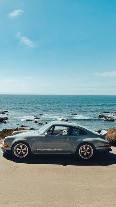 a car parked in front of the ocean