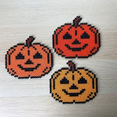 three pumpkins made out of perler beads