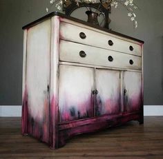 an old dresser painted with pink and white paint