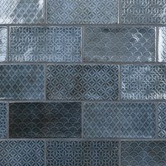 a close up view of a glass block wall with an intricate design on it's side