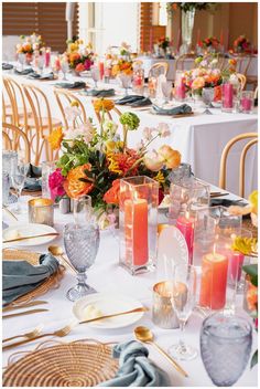 a table set with candles and flowers on it