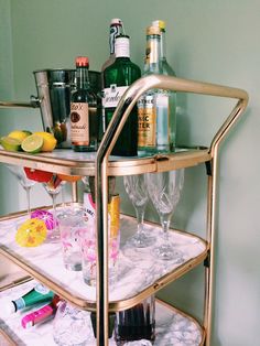 a bar cart filled with liquor bottles and glasses