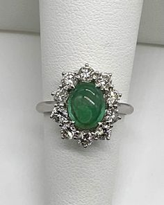 Beautiful estate genuine oval cabochon cut emerald and natural diamonds in solid 18k white gold. Emerald is prong set in the center of the ring is an A quality 8.5x6.5 mm. and 1CTW.  Has a few natural features like veins, a cloud and some dark inclusions.  Diamonds all prong set, there are 10 round cut stones 1.2 TCW F-G color, VS2-SI1 clarity. Will fit 5.75 US finger size. Truly beautiful ring. Was appraised by 3rd party independent GIA graduate jeweler.  Please ask any questions you might have. Thank you. Luxury White Gold Oval Cabochon Emerald Ring, Fine Jewelry White Gold Emerald Cabochon Ring, Fine Jewelry White Gold Cabochon Emerald Ring, White Gold Cabochon Emerald Ring Fine Jewelry, Elegant White Gold Cabochon Emerald Ring, Elegant White Gold Emerald Cabochon Ring, Formal White Gold Emerald Ring With Oval Cabochon, Hallmarked Oval Emerald Ring In Platinum, Oval Hallmarked Emerald Ring In Platinum