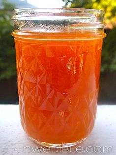 a glass jar filled with liquid sitting on top of a table