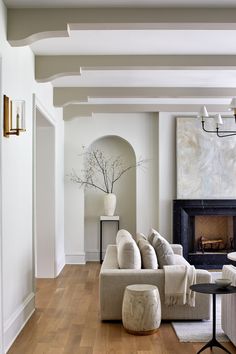 a living room filled with furniture and a fire place in the middle of a room