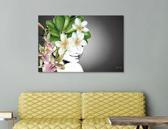 a woman with flowers in her hair sitting on a yellow couch next to a table