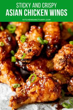 chicken wings covered in sauce and green onions