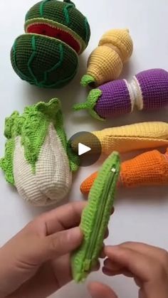 someone is holding an object in their hand and it looks like they are made out of knitted vegetables