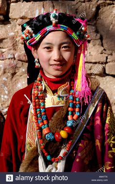 a young woman in traditional dress and headdress