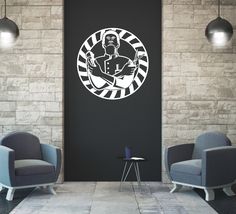 two chairs and a table in front of a black wall with a white graphic on it