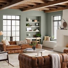 a living room filled with lots of furniture next to a fire place in a fireplace