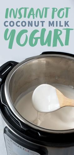 a wooden spoon in a slow cooker filled with coconut milk