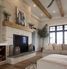 a living room with a couch, fireplace and tv in it's centerpiece