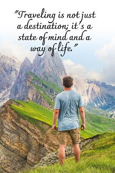 a man standing on top of a lush green hillside next to a mountain with a quote about traveling