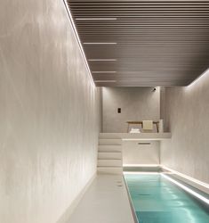 an indoor swimming pool in the middle of a room