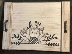 a wooden tray with black and white designs on it