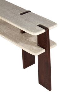 a bench made out of concrete and wood with one leg bent down to the side